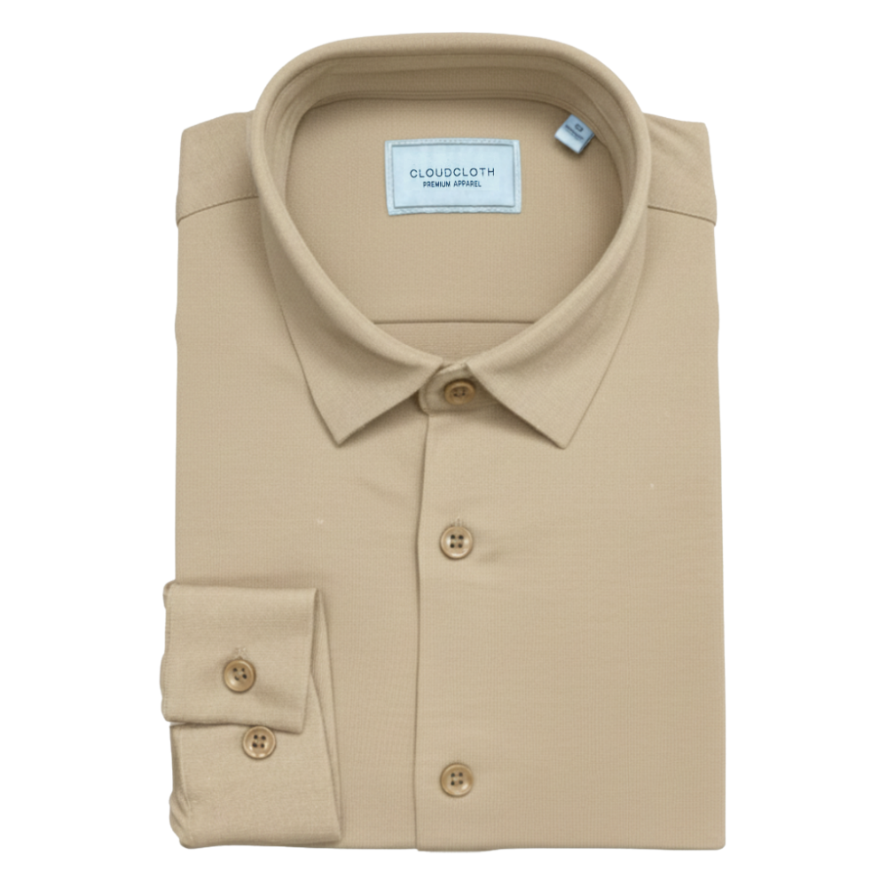 Folded beige shirt with CloudCloth label on a white background