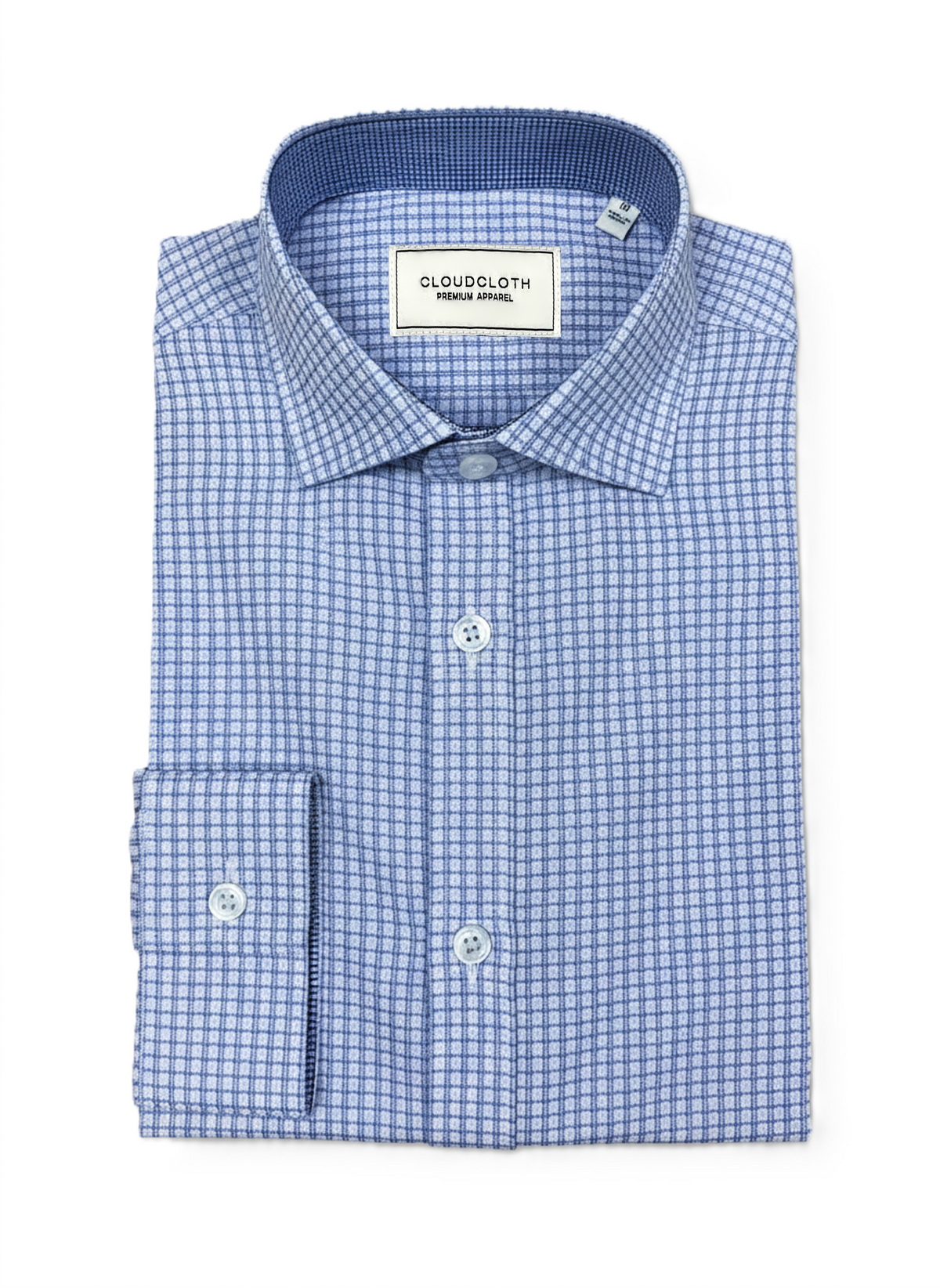 A folded men's dress shirt by Cloudcloth, featuring a blue and white micro-check pattern, a classic collar, and a button-down front.