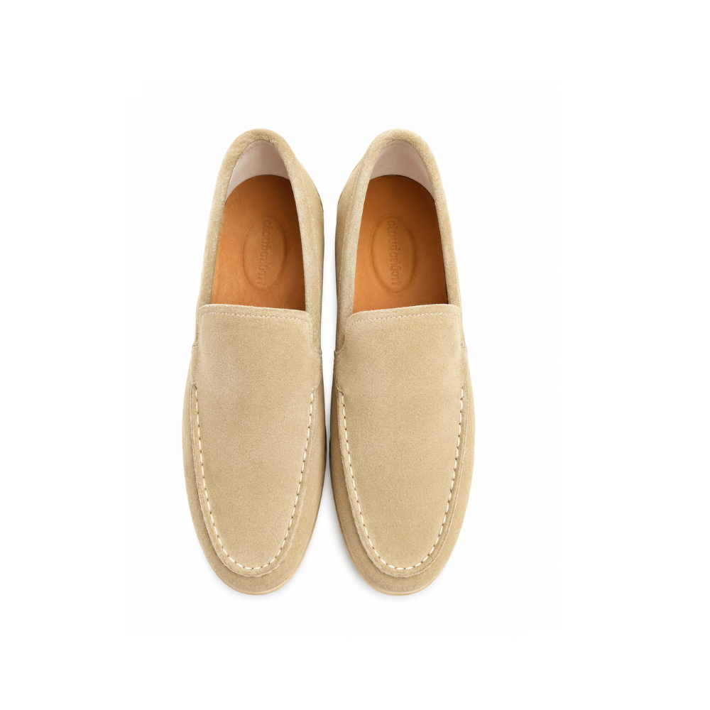 Pair of beige loafers on a white background