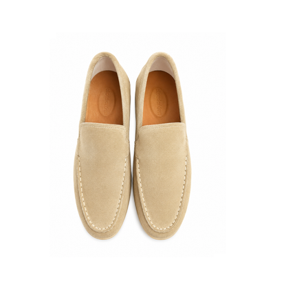 Pair of beige loafers on a white background