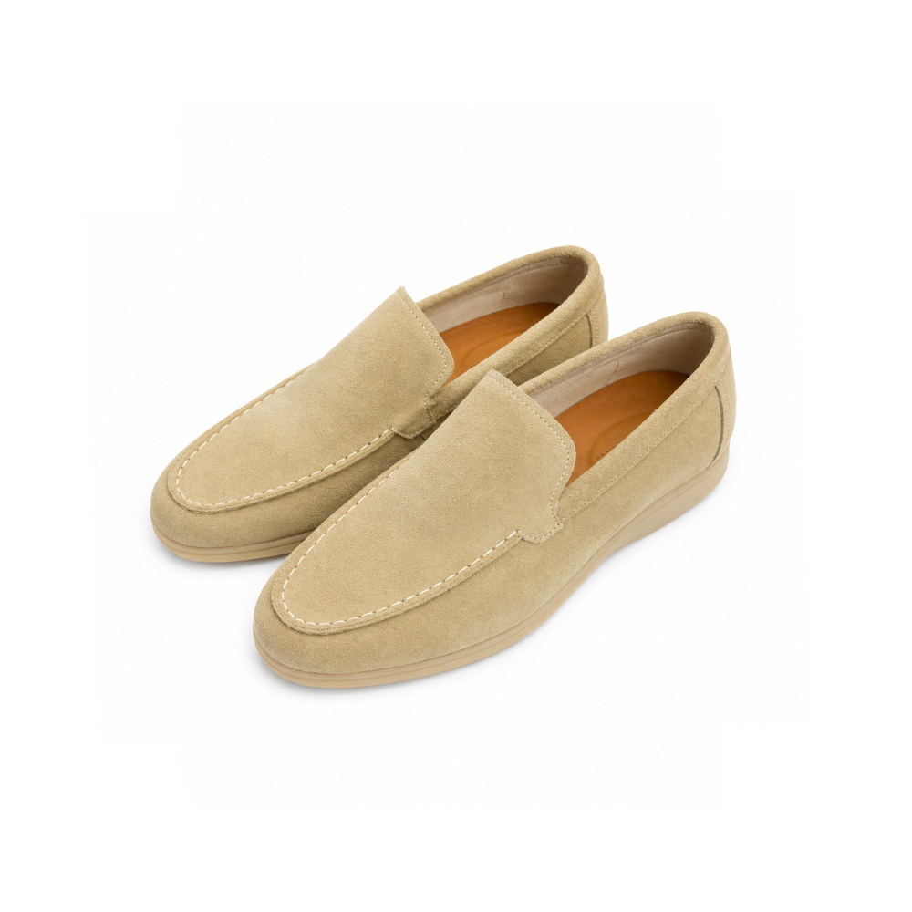 Pair of beige loafers on a white background