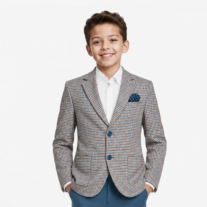 Young boy wearing a checkered blazer with a white shirt and blue pants on a white background