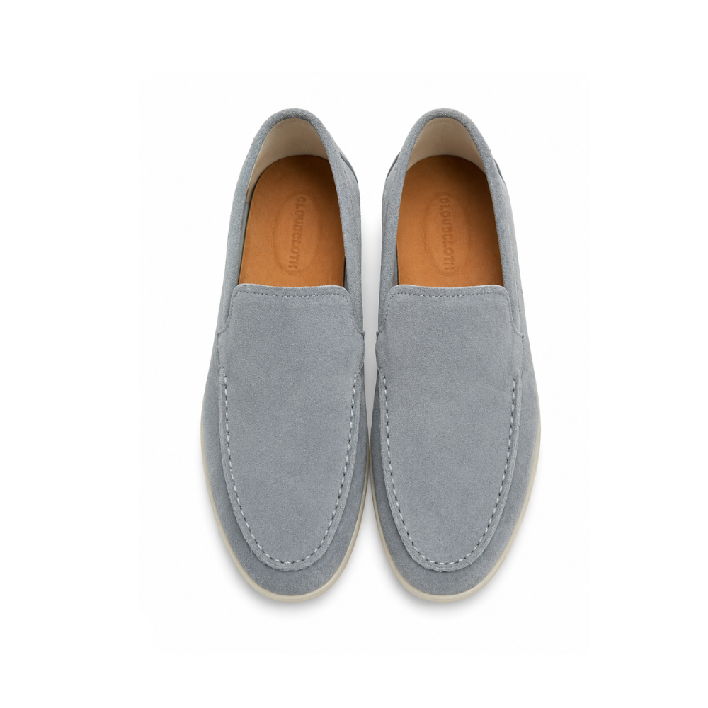 Pair of gray suede loafers on a white background