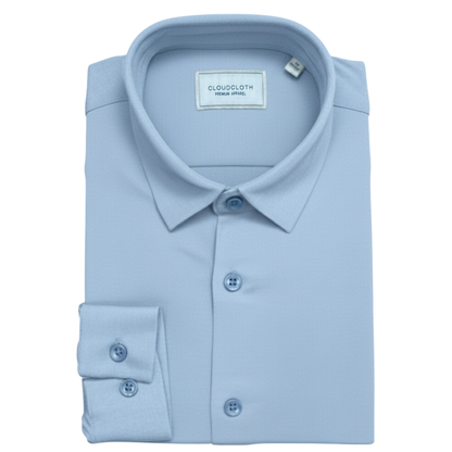 Folded light blue dress shirt with CloudCloth label on a white background