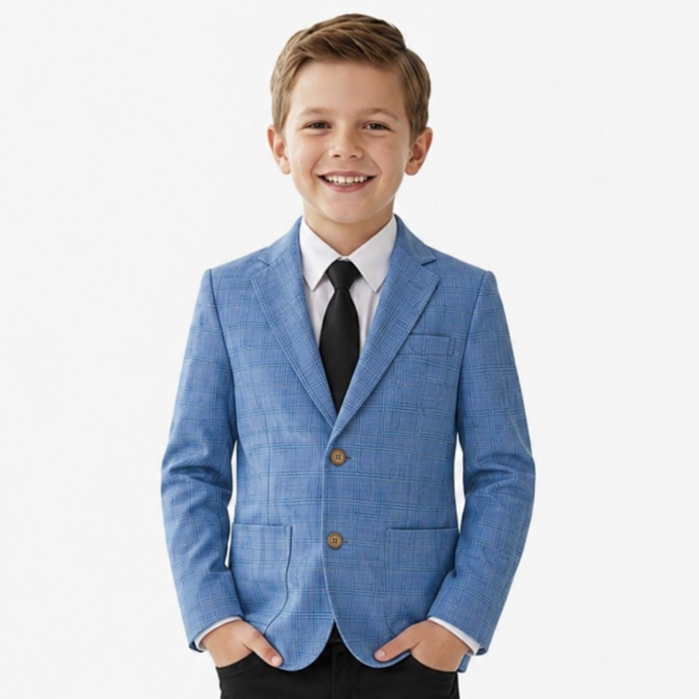 Young boy wearing a blue checkered blazer with a white shirt and black tie on a white background