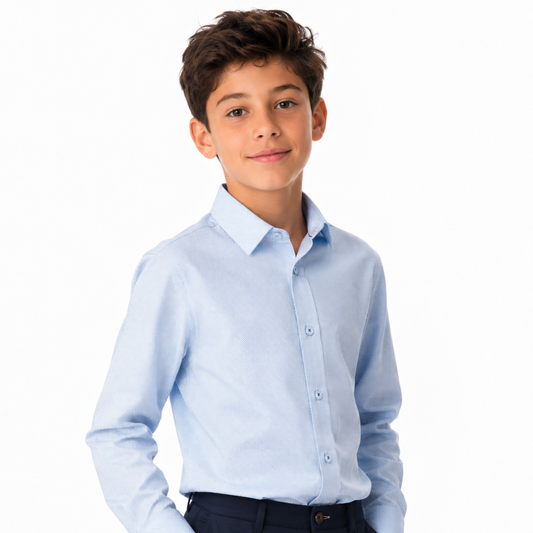 Young boy wearing a light blue dress shirt on a white background