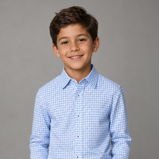 Young boy wearing a blue checkered shirt against a gray background