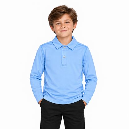 A young boy with brown hair wearing a light blue long-sleeve polo shirt and black pants, standing against a solid white background.