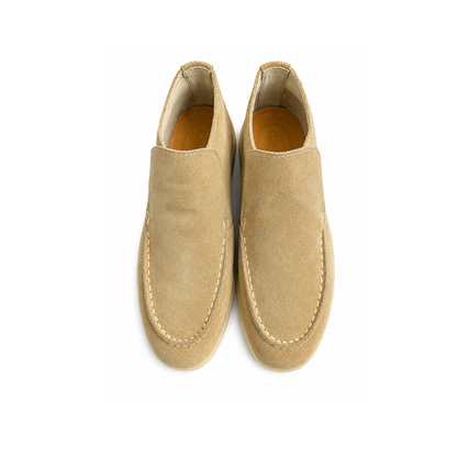 Pair of tan suede loafers on a white background
