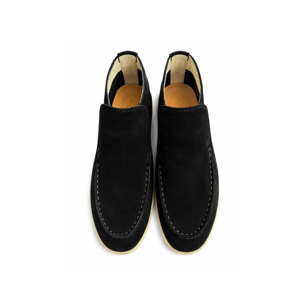 Pair of black loafers on a white background