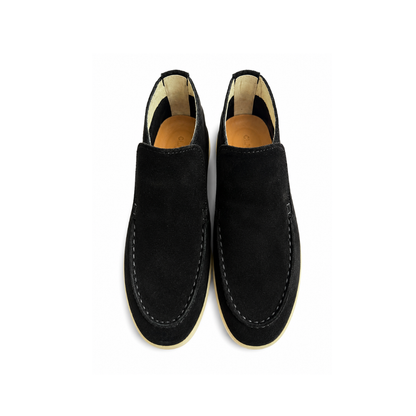 Pair of black loafers on a white background