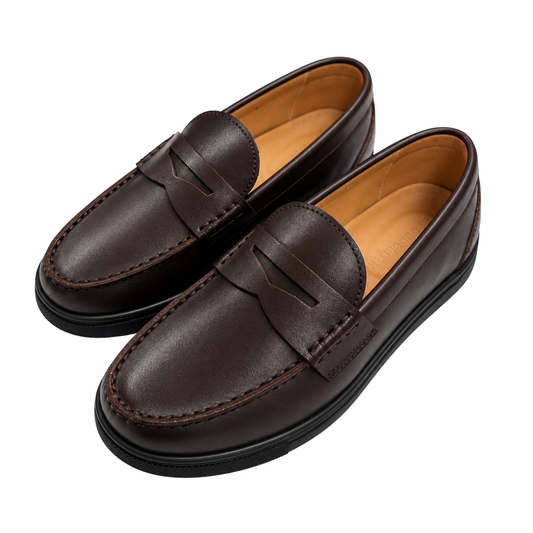 A pair of dark brown leather penny loafers with a tan interior lining, shown from a high-angle view on a solid white background.