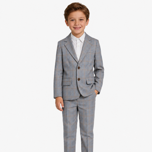 Young boy wearing a gray checkered suit on a white background