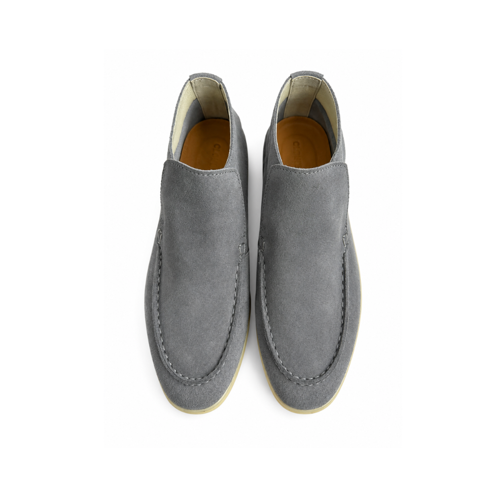 Pair of gray suede loafers on a white background