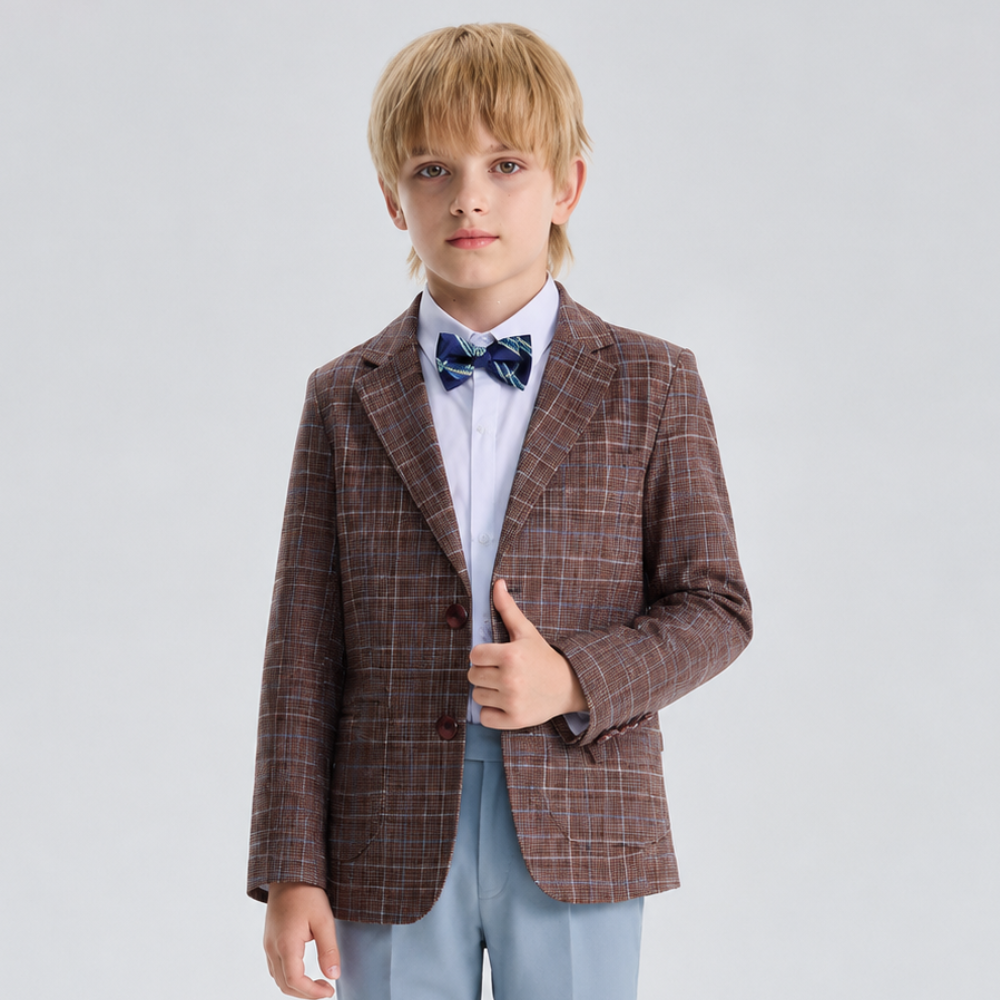 Young boy wearing a brown plaid blazer, light blue shirt, and bow tie on a white background