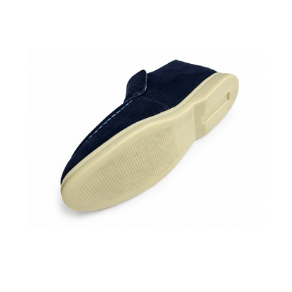 Navy slip-on shoe with a white sole on a white background