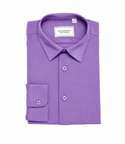 A folded purple long-sleeve dress shirt with a pointed collar, button-down front, and a single cuff with a button, shown on a plain white background. The brand label reads 'ELUSDBLOTH'.