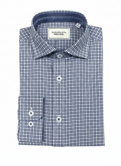 A folded men's dress shirt by Cloudcloth, featuring a blue and white micro-check pattern, a classic collar, and a button-down front.